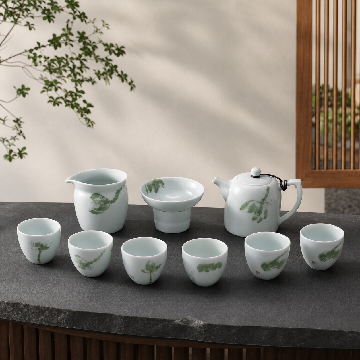Nine-piece celadon tea set on a charcoal stone table